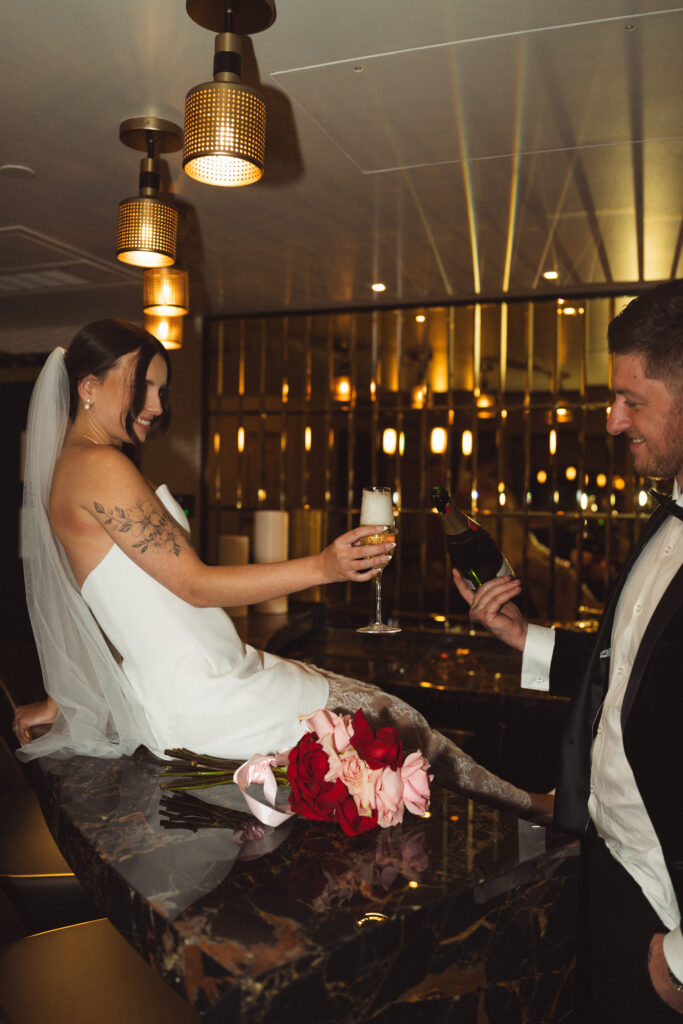 Las Vegas Elopement Photographer couple with champagne